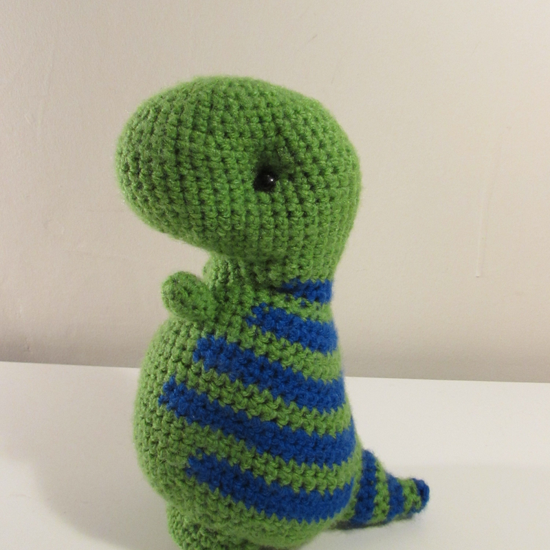 Green dinosaur with blue stripes