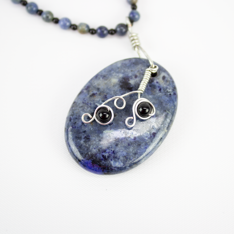 Blue dumortierite and onyx stone beaded necklace with large oval pendant and silver plated wirework accents