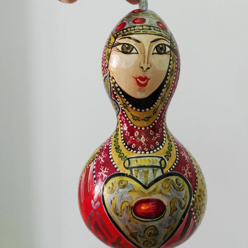 Woman Drawing on Dried Pumpkin