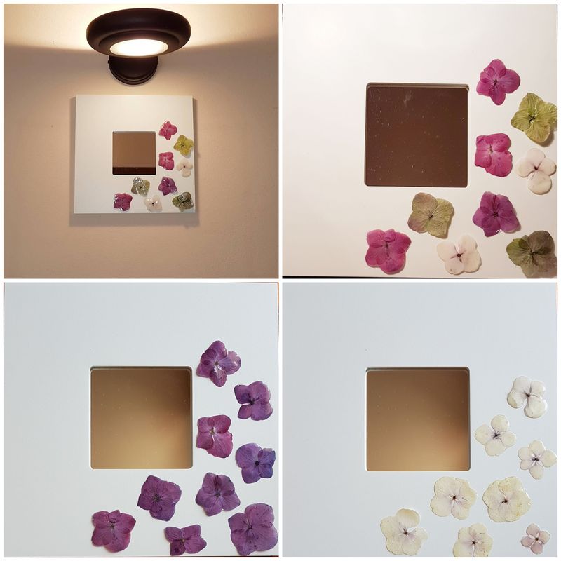 Mirror in white lacquered wooden frame. real flowers covered with transparent resin