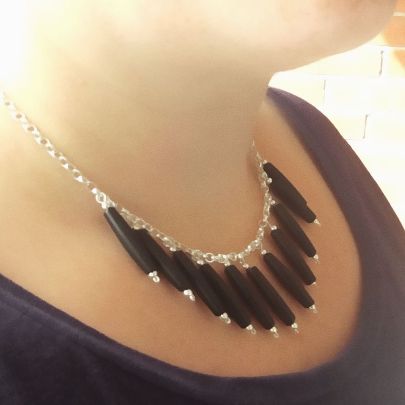 Edgy sterling silver bib necklace with black bone beads