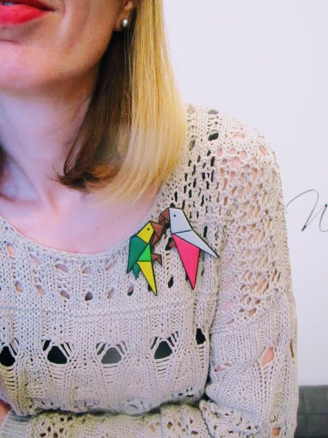 Origami style parrot brooch made from polymer clay in green and yellow tones