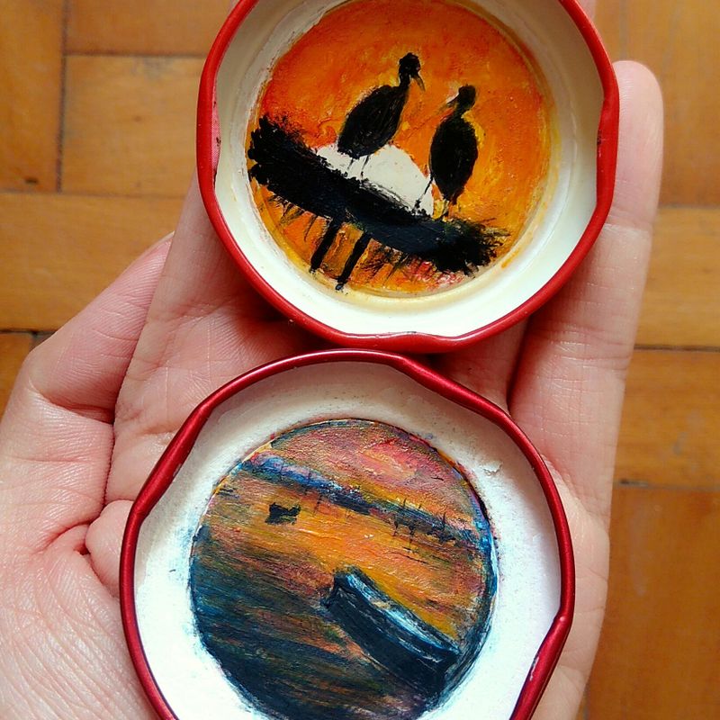 hand painted landscapes in bottle caps