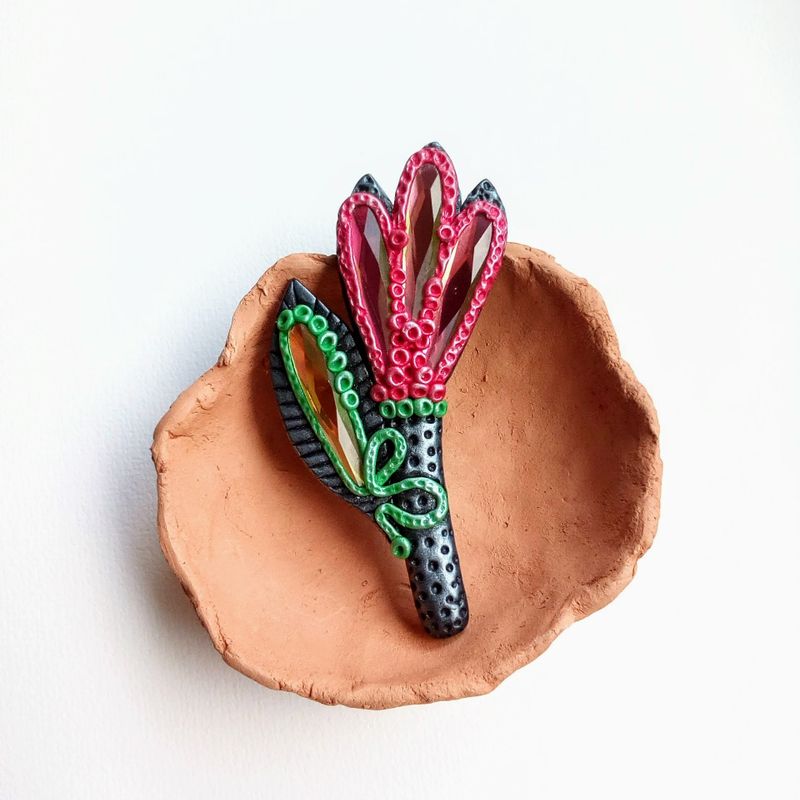 One of a kind polymer clay flower brooch in black and red tones decorated with glass crystals