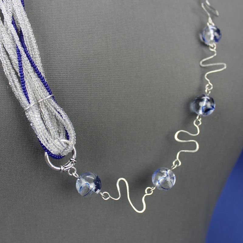 Unique asymmetrical glass bead necklace with wirework links, blue, clear, and silver